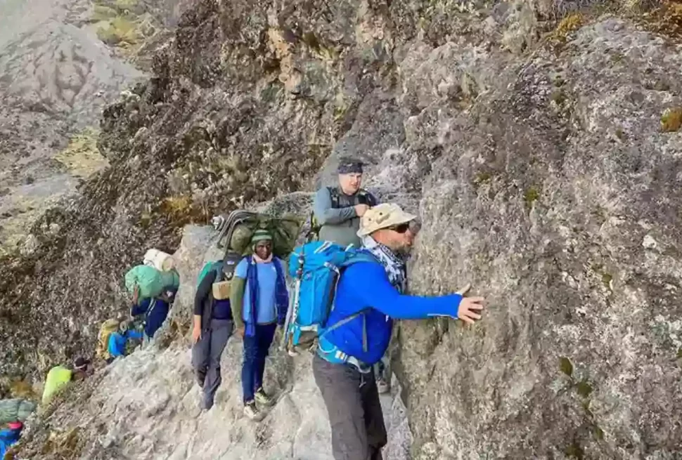 Group of trekkers navigating the Barranco Wall during a Kilimanjaro expedition.